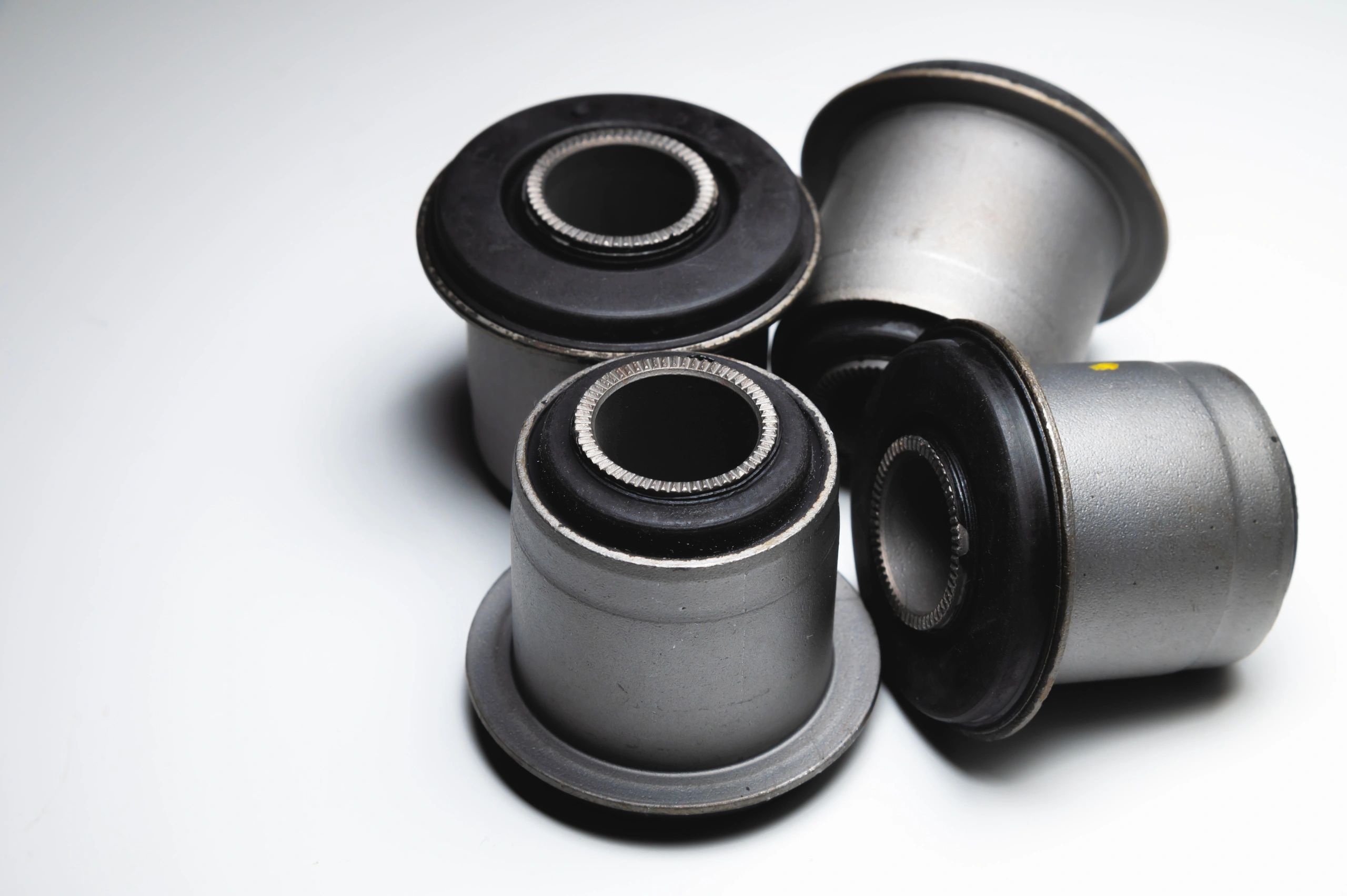 Close-up. A group of cylindrical silent blocks for the front suspension of an off-road vehicle. Contrast light low key